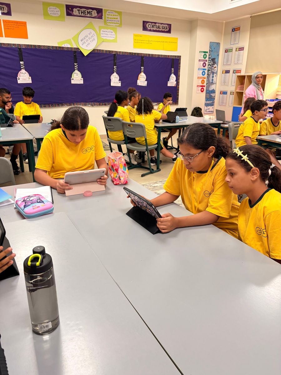 PYP students researching on tablets in an EVO classroom