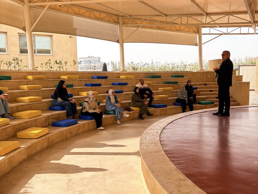 Families gathering in the amphitheatre on an open morning